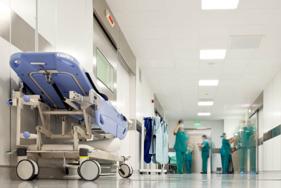 Blurred figures of people with medical uniforms in hospital corridor